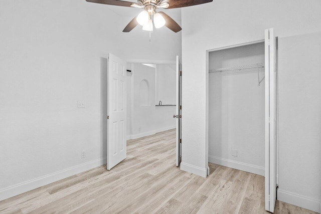 unfurnished bedroom with light wood-type flooring, baseboards, a closet, and ceiling fan