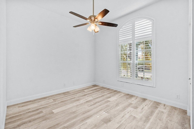 unfurnished room with light wood finished floors, a ceiling fan, and baseboards