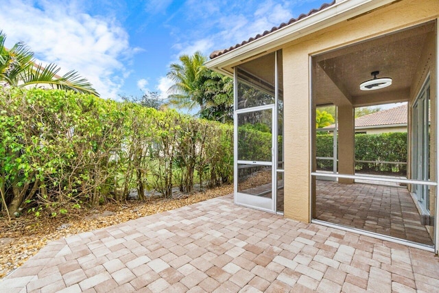 view of patio featuring a sunroom