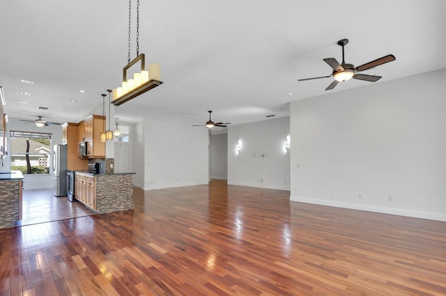 unfurnished living room featuring dark wood-style floors, baseboards, and ceiling fan