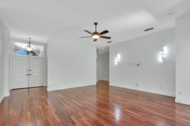 unfurnished living room with visible vents, baseboards, ceiling fan, and wood finished floors