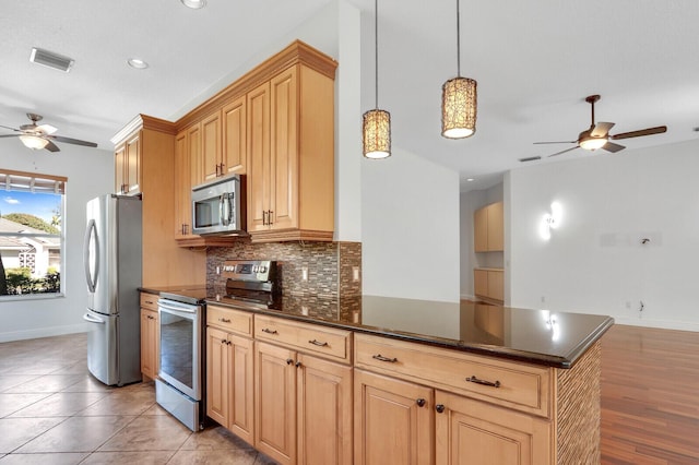 kitchen with visible vents, backsplash, appliances with stainless steel finishes, a peninsula, and a ceiling fan