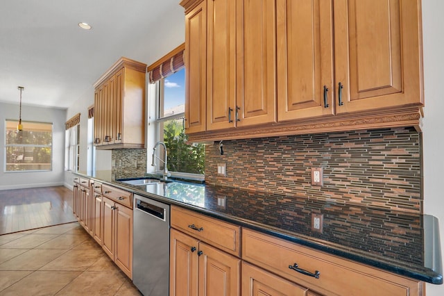 kitchen with tasteful backsplash, dishwasher, pendant lighting, light tile patterned floors, and a sink