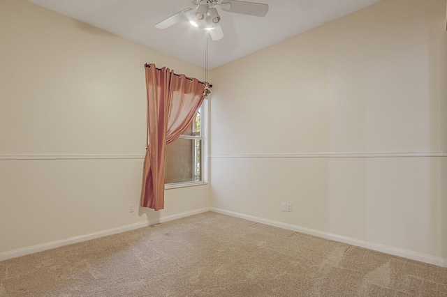 empty room featuring carpet, baseboards, and ceiling fan