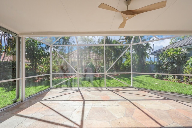 unfurnished sunroom with a wealth of natural light and ceiling fan