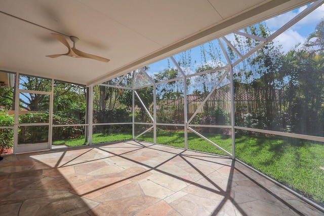 unfurnished sunroom with a ceiling fan