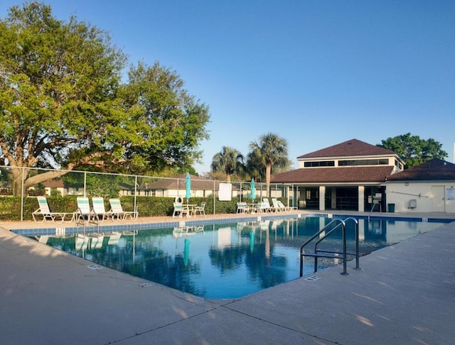 pool featuring a patio area and fence