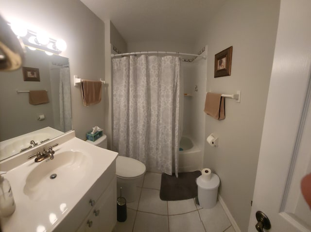 bathroom featuring vanity, baseboards, tile patterned flooring, shower / bath combo with shower curtain, and toilet