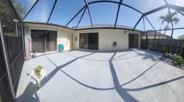 exterior space featuring a lanai and fence