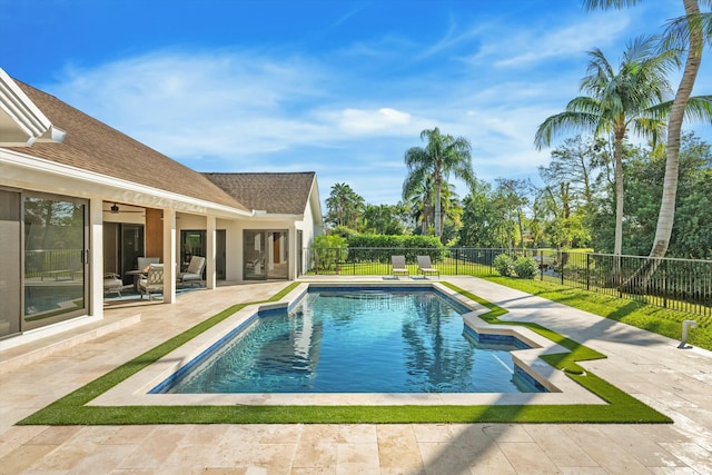 view of pool with a fenced in pool, a fenced backyard, a ceiling fan, and a patio area