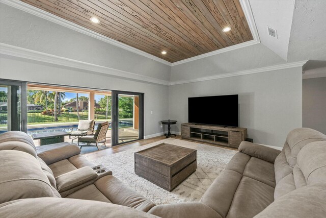 living room featuring visible vents, wood ceiling, ornamental molding, wood finished floors, and a raised ceiling