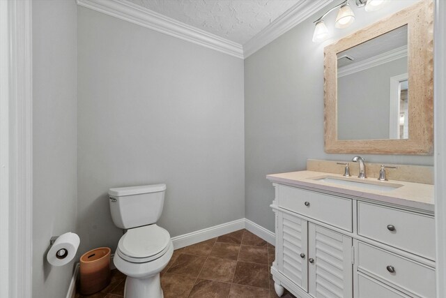 bathroom featuring tile patterned flooring, crown molding, toilet, and vanity