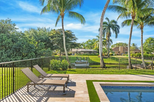 view of pool with a fenced in pool, a patio, a yard, and fence