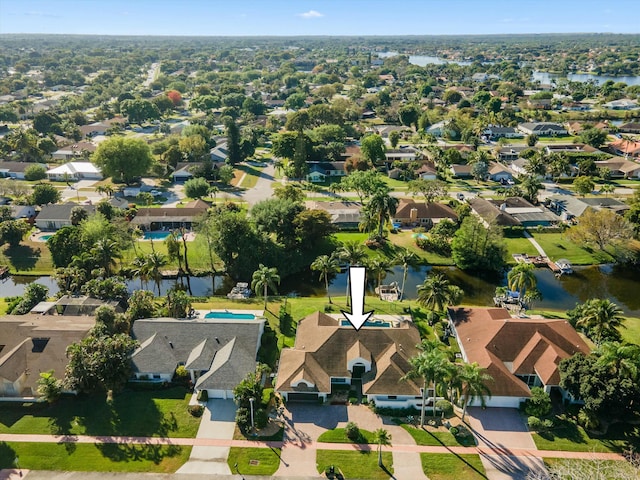 drone / aerial view featuring a residential view and a water view