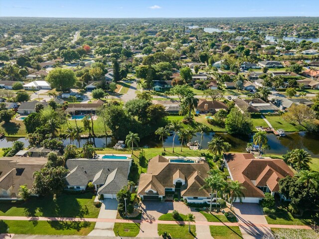 drone / aerial view with a residential view and a water view