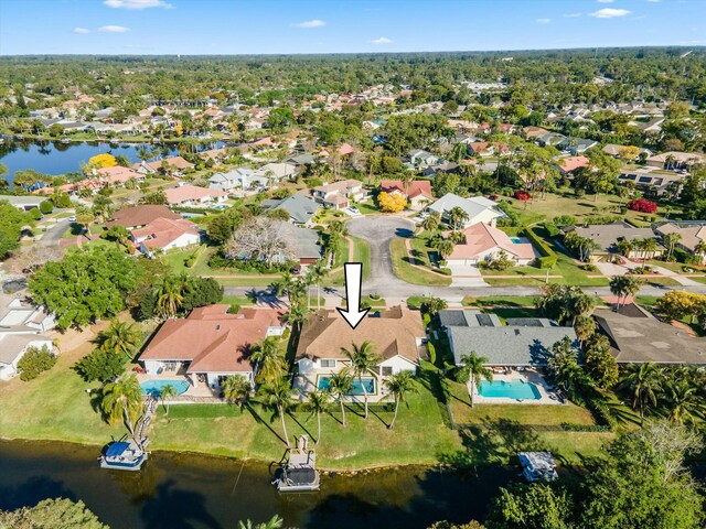 drone / aerial view featuring a residential view and a water view