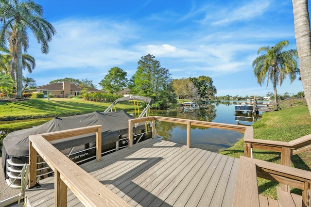 dock area with a yard and a water view