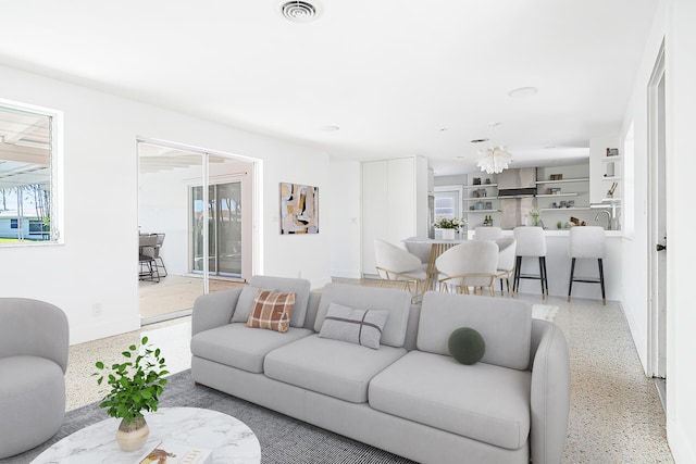 living room with visible vents and speckled floor