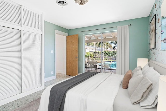 bedroom with speckled floor, baseboards, visible vents, a closet, and access to outside