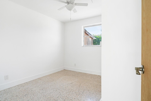 unfurnished room featuring baseboards and a ceiling fan