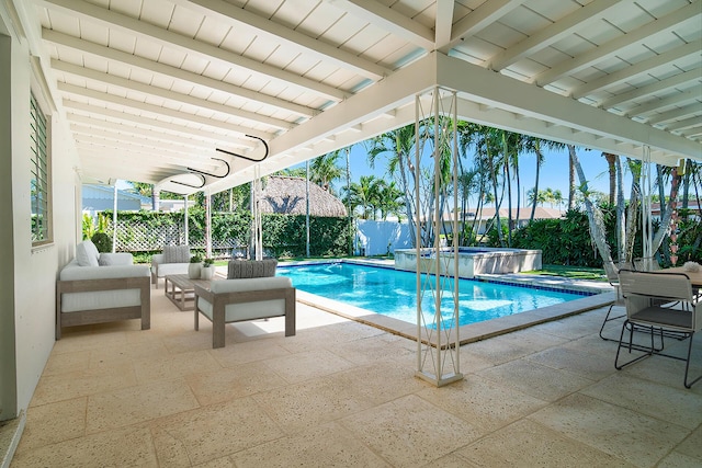 view of swimming pool with a patio area, a pool with connected hot tub, outdoor lounge area, and a fenced backyard