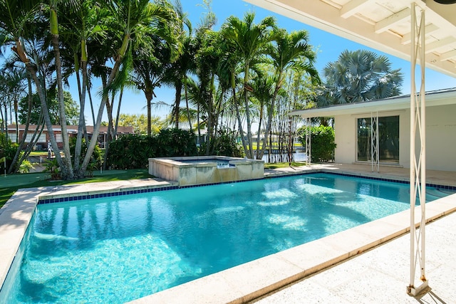 view of pool with a pool with connected hot tub