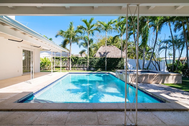 view of pool featuring a fenced in pool, an in ground hot tub, a fenced backyard, and a patio