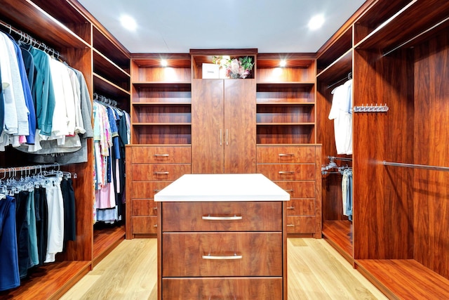 walk in closet with light wood-type flooring