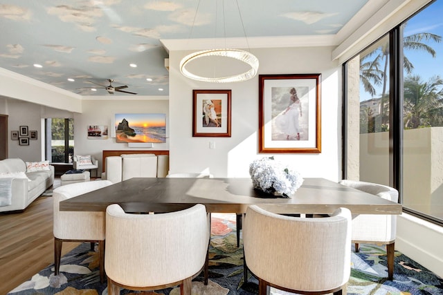 dining area featuring crown molding, recessed lighting, wood finished floors, and baseboards