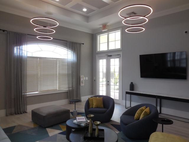 living room with crown molding, baseboards, french doors, a high ceiling, and coffered ceiling