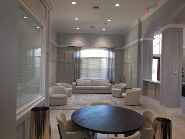 living area with visible vents, light wood finished floors, ornate columns, recessed lighting, and crown molding