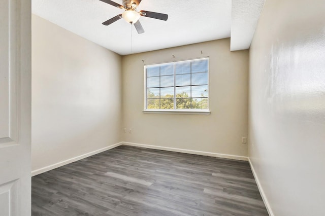 spare room featuring a textured ceiling, wood finished floors, baseboards, and ceiling fan