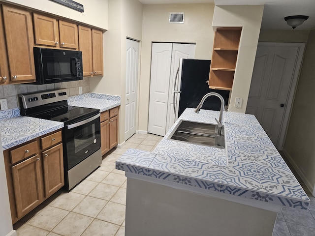 9833 Baywinds Dr Unit 7307, West Palm Beach, FL 33411 - kitchen featuring electric range, black microwave, light tile patterned floors, tasteful backsplash, and open shelves