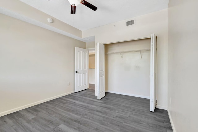 9833 Baywinds Dr Unit 7307, West Palm Beach, FL 33411 - unfurnished bedroom featuring wood finished floors, a closet, and a ceiling fan