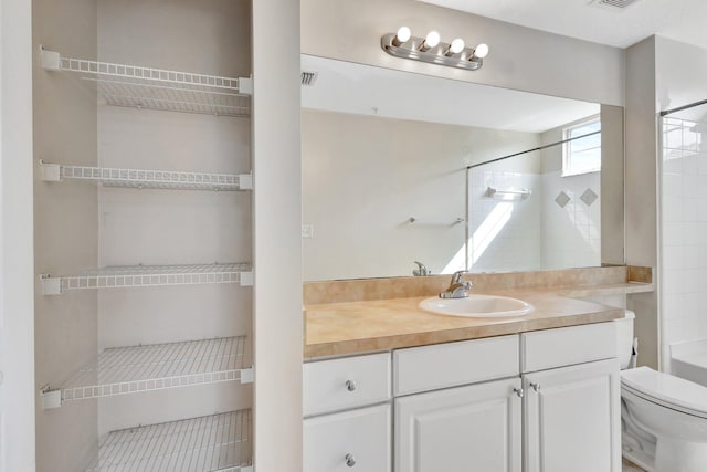 bathroom featuring visible vents, toilet, and vanity