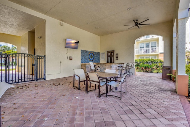 view of patio featuring a gate and a ceiling fan