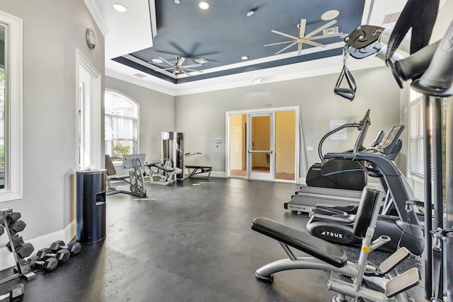 gym featuring baseboards, a tray ceiling, recessed lighting, ceiling fan, and crown molding