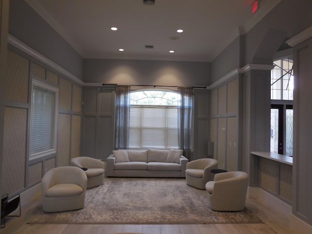 living room featuring crown molding, recessed lighting, wood finished floors, and visible vents