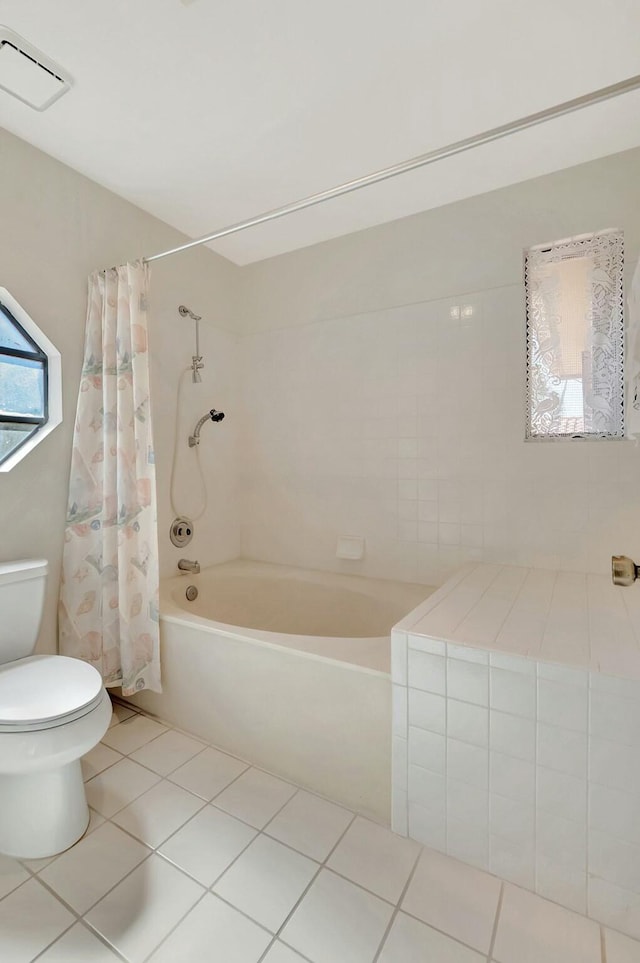 bathroom with tile patterned floors, visible vents, toilet, and shower / bath combo