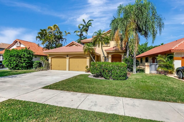 mediterranean / spanish house with a front yard, stucco siding, concrete driveway, a garage, and a tiled roof