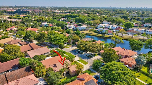 drone / aerial view featuring a residential view and a water view