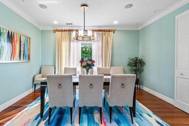 dining space with a chandelier, wood finished floors, baseboards, and ornamental molding