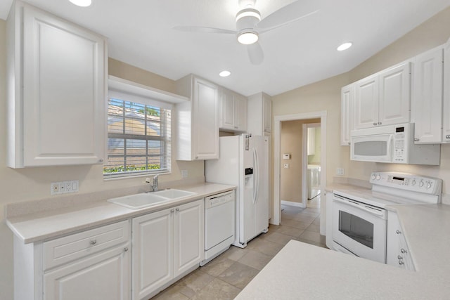 kitchen with white appliances, white cabinets, light countertops, and a sink