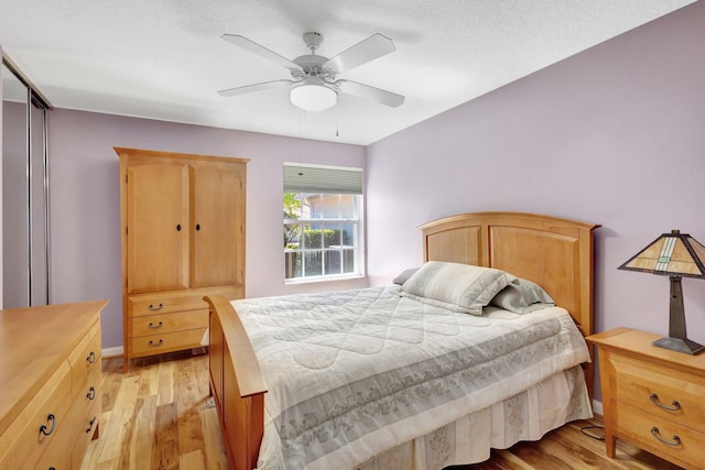 bedroom with light wood-style floors and ceiling fan