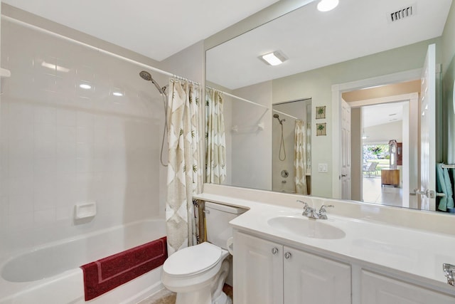 full bathroom featuring visible vents, vanity, toilet, and shower / tub combo with curtain