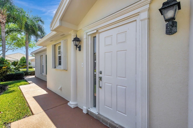 doorway to property with stucco siding