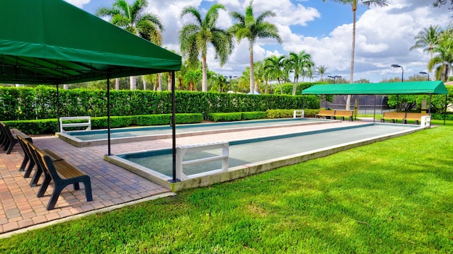 view of pool with a lawn