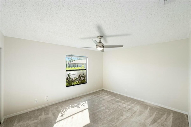 unfurnished room featuring ceiling fan, baseboards, carpet floors, and a textured ceiling