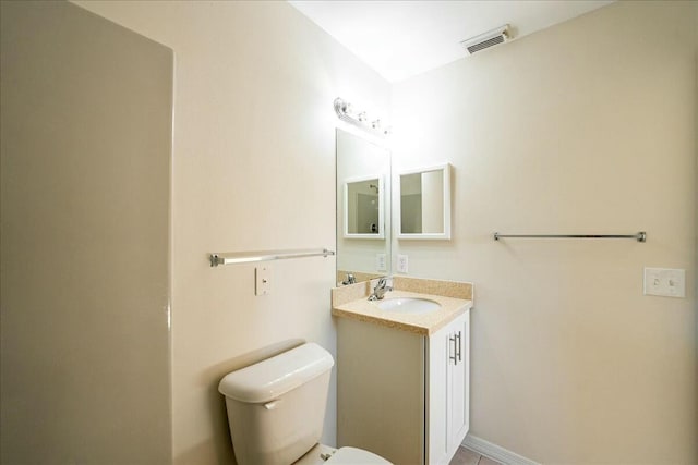 bathroom with visible vents, toilet, and vanity