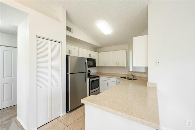 kitchen featuring visible vents, a sink, appliances with stainless steel finishes, white cabinets, and light countertops